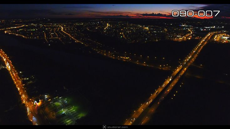 Night illuminated highway of rolling city streets and districts – Drone Aerial...