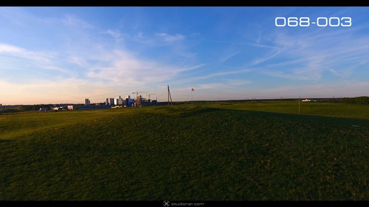 The meadows with a factory on the horizon – Drone Aerial Photography, Videogra...