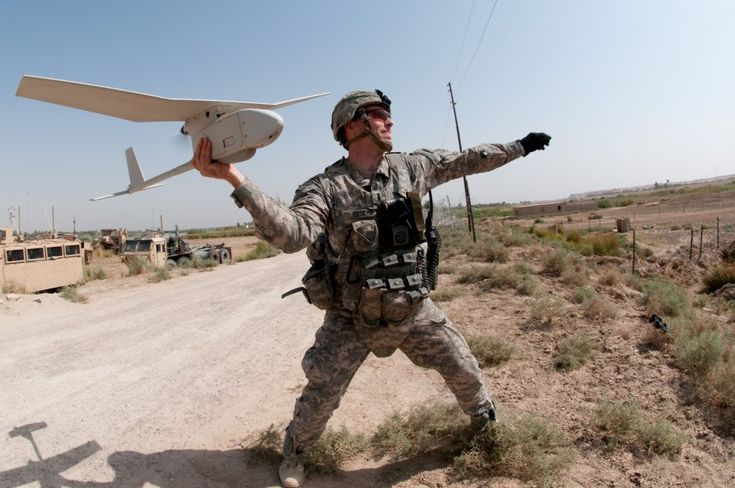 A US Army soldier launches a Raven hand-held drone in Iraq. US Army photo