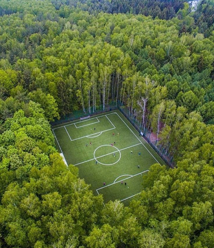 Drone shot of a soccer field in the middle of the woods in Moscow By  crunchcrew