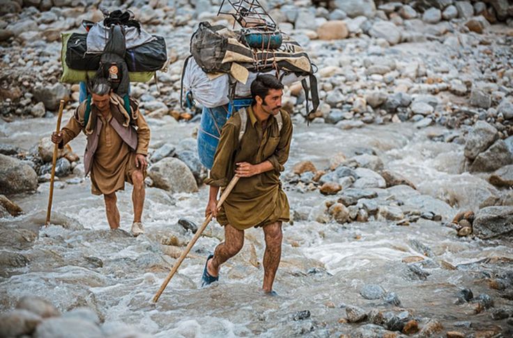Balti porters carrying loads which range from 25kg to 50kg, a task they undertake often wearing only basic rubber sneakers filled with fresh grass to stop their feet slipping. PHOTO: DAVID KASZLIKOWSKI